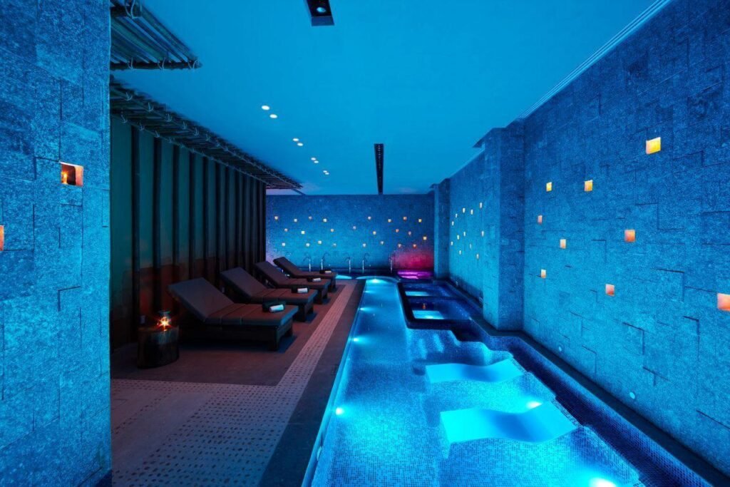 Indoor swimming pool with blue lights at Banyan